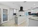 Modern kitchen with stainless steel appliances, a center island, and ample cabinet space and pantry at 8718 Tahiti Ln, Tampa, FL 33615