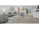 Stylish living room flowing into an open floor plan, showcasing modern furniture and decor at 8718 Tahiti Ln, Tampa, FL 33615