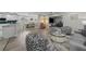 Open-concept living space featuring stylish furniture, hardwood floors, and abundant natural light at 8718 Tahiti Ln, Tampa, FL 33615