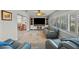 Spacious living room featuring custom entertainment center, comfortable seating, and plantation shutters at 8718 Tahiti Ln, Tampa, FL 33615
