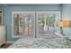 Main bedroom with plantation shutters overlooking outdoor deck at 8718 Tahiti Ln, Tampa, FL 33615