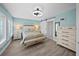Light and airy main bedroom with neutral furniture, ceiling fan, and ensuite bathroom at 8718 Tahiti Ln, Tampa, FL 33615