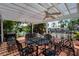 Charming covered patio with ceiling fans overlooking the tranquil canal and lush tropical landscaping at 8718 Tahiti Ln, Tampa, FL 33615