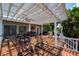 Outdoor patio with fans, multiple seating areas, a grill, and decorative lighting, great for entertaining at 8718 Tahiti Ln, Tampa, FL 33615