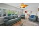 Comfortable sunroom featuring plantation shutters, leaf-blade ceiling fan, and access to the bedroom at 8718 Tahiti Ln, Tampa, FL 33615
