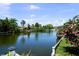 Breathtaking water view showcasing lush landscaping and vibrant floral accents along the canal at 8718 Tahiti Ln, Tampa, FL 33615