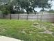 Large, grassy backyard enclosed by a wooden fence providing privacy and space at 8801 Orange Blossom Dr, Seminole, FL 33772