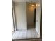 Hallway area with white tile flooring leading to other rooms at 8801 Orange Blossom Dr, Seminole, FL 33772