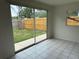 Bright living area featuring tile floors and sliding glass doors to the backyard at 8801 Orange Blossom Dr, Seminole, FL 33772