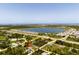 Wide aerial view of property with neighborhood, lake and the ocean visible in the distance at 9073 Fruitland Ave, Englewood, FL 34224