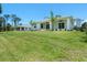 Expansive backyard with lush green grass extends from home, showing covered patio feature at 9073 Fruitland Ave, Englewood, FL 34224