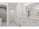 Well-lit bathroom with dual vanities, quartz countertop, modern fixtures, and glass-enclosed walk-in shower at 9073 Fruitland Ave, Englewood, FL 34224