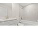 A modern bathroom with a sleek vanity, tub, and tiled shower at 9073 Fruitland Ave, Englewood, FL 34224