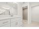 Bathroom with white cabinetry, quartz countertop, modern fixtures, and glass-enclosed walk-in shower at 9073 Fruitland Ave, Englewood, FL 34224