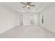 Large bedroom featuring a ceiling fan, ensuite bathroom, walk-in closet, and tiled floors at 9073 Fruitland Ave, Englewood, FL 34224