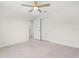 This bedroom features neutral walls, a ceiling fan, tile floor and closet at 9073 Fruitland Ave, Englewood, FL 34224