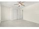 This bedroom features neutral walls, a ceiling fan, tile floor and closet at 9073 Fruitland Ave, Englewood, FL 34224
