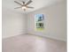 Bright bedroom featuring a ceiling fan and large windows offering abundant light at 9073 Fruitland Ave, Englewood, FL 34224