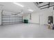 Spacious garage featuring an epoxy floor and ample storage space at 9073 Fruitland Ave, Englewood, FL 34224
