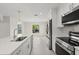 Modern kitchen with stainless steel appliances, a white quartz countertop, and recessed lighting at 9073 Fruitland Ave, Englewood, FL 34224