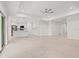 Spacious open-concept living space with tiled floors, recessed lighting, and a kitchen island at 9073 Fruitland Ave, Englewood, FL 34224