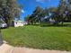 Exterior backyard with a grassy field and backyard shed at 9171 Vicksburg Rd, Spring Hill, FL 34608
