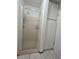 Bathroom with glass-enclosed shower and built-in storage at 9171 Vicksburg Rd, Spring Hill, FL 34608