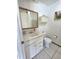 Bathroom featuring a vanity, toilet, and medicine cabinet, designed for functionality at 9171 Vicksburg Rd, Spring Hill, FL 34608