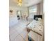 Well-lit bedroom with tile floors, dinosaur themed bed, and curtained window at 9171 Vicksburg Rd, Spring Hill, FL 34608