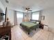 Spacious bedroom with tile floors, ceiling fan, and a dresser with a television at 9171 Vicksburg Rd, Spring Hill, FL 34608