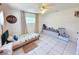 Bright bedroom featuring neutral walls, tile floors, curtains, and a ceiling fan at 9171 Vicksburg Rd, Spring Hill, FL 34608