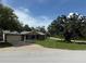 Charming single-story home with stone accents, attached garage, and a well-manicured front lawn in a serene setting at 9171 Vicksburg Rd, Spring Hill, FL 34608