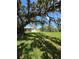 A charming property with lush greenery and a large oak tree at 9171 Vicksburg Rd, Spring Hill, FL 34608