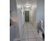 Hallway with tile floors and neutral walls, leading to bedrooms and bathrooms at 9171 Vicksburg Rd, Spring Hill, FL 34608