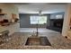 Open concept kitchen with a view of the living room fireplace at 9171 Vicksburg Rd, Spring Hill, FL 34608