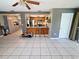 Open living space featuring a breakfast bar connecting to the kitchen at 9171 Vicksburg Rd, Spring Hill, FL 34608