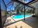 Screened-in outdoor pool for year-round enjoyment and relaxation at 9171 Vicksburg Rd, Spring Hill, FL 34608