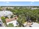 This aerial view captures the home surrounded by mature trees and also shows the proximity to commercial business and retail at 9312 N Tampa St, Tampa, FL 33612