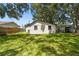 This home boasts a large, green backyard, shaded by mature trees at 9312 N Tampa St, Tampa, FL 33612