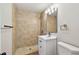 Updated bathroom showcasing a tiled shower, modern vanity, and neutral color palette at 9312 N Tampa St, Tampa, FL 33612