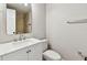 Updated bathroom with white vanity, stylish mirror, and walk-in shower with neutral tiling at 9312 N Tampa St, Tampa, FL 33612