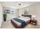 Cozy bedroom features a comfortable bed, soft rug, and ample natural light from two windows at 9312 N Tampa St, Tampa, FL 33612