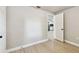 View from bright bedroom through the doorway to kitchen with white cabinetry and black backsplash at 9312 N Tampa St, Tampa, FL 33612