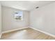 Bedroom featuring wood-look flooring, a window, and neutral-painted walls at 9312 N Tampa St, Tampa, FL 33612