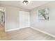 Bedroom featuring a double closet, wood-look flooring, fresh paint and a window at 9312 N Tampa St, Tampa, FL 33612