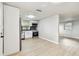 Bright kitchen with white cabinets, stainless steel appliances, a backsplash, and wood-look flooring throughout at 9312 N Tampa St, Tampa, FL 33612
