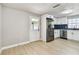 Charming kitchen with stainless steel appliances, white cabinets, and stylish backsplash, with room for dining at 9312 N Tampa St, Tampa, FL 33612