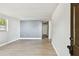 Bright living room featuring modern flooring, fresh paint, and large window at 9312 N Tampa St, Tampa, FL 33612