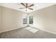 Bedroom with wall-to-wall carpeting, a ceiling fan and natural lighting from the two windows at 9807 Stephenson Dr, New Port Richey, FL 34655
