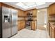 Traditional kitchen with stainless steel appliances, tile backsplash, and contrasting tile floors at 9807 Stephenson Dr, New Port Richey, FL 34655